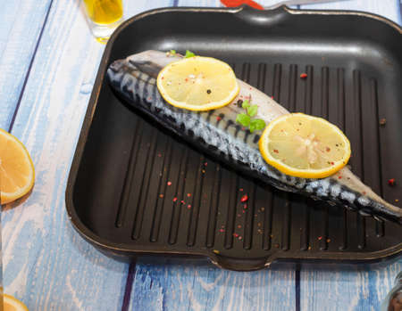 Raw mackerel fish. Cooking fish in a pan.の写真素材