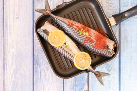 Raw mackerel fish. Cooking fish in a pan.の写真素材