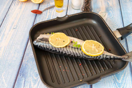 Raw mackerel fish. Cooking fish in a pan.の写真素材