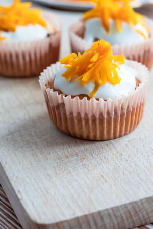 Homemade pumpkin muffins. on a wooden board.