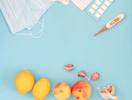 Hospital masks on a blue background. Medicines and fruits lieの写真素材