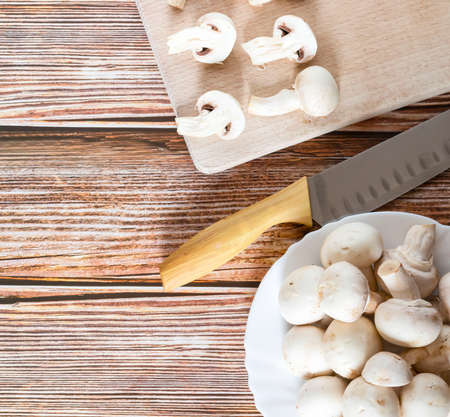 Fresh porcini mushrooms on a cutting board. On a tree backgroundの写真素材