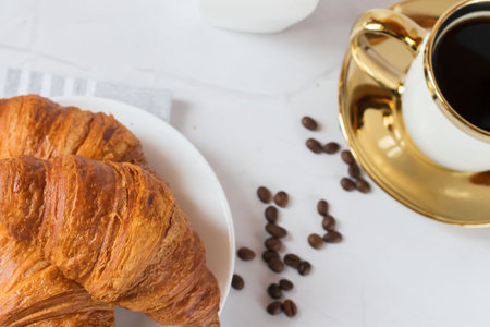 Breakfast with coffee and croissant on table, stock photoの写真素材