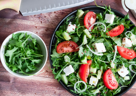 Fresh salad with arugula, tomato, feta cheese and cucumberの写真素材