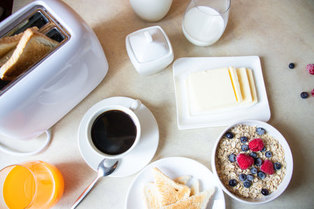 Healthy breakfast with oatmeal, berries, toasts and coffeeの写真素材