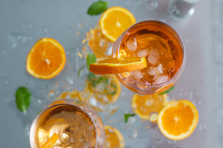 Cocktails with ice, orange and mint on a gray backgroundの写真素材