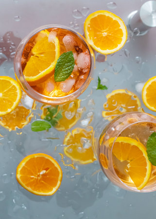 Cocktail with orange, lemon and mint on a gray background