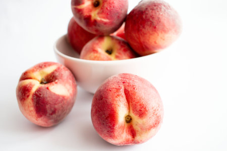 Fresh peaches in a bowl on a white background. selective focus.の写真素材