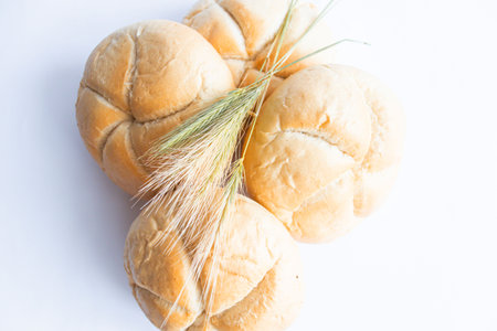 Fresh bread with wheat ears on a white background. top view.の写真素材