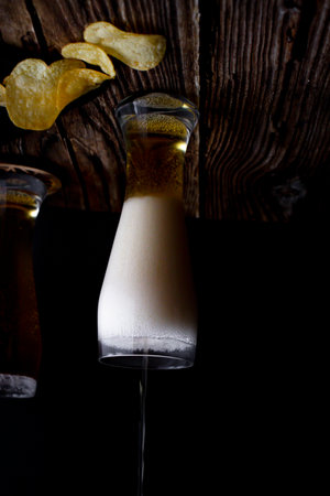 Pina colada with potato chips on a dark background. selective focus.の写真素材