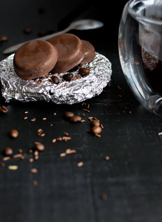 Chocolate macaroons with coffee beans on a black background.の写真素材