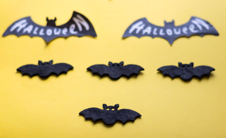 Halloween bats on a yellow background. Selective focus. Holiday.