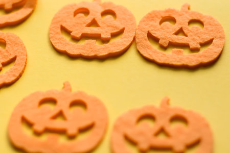 Halloween decoration on a yellow background. Orange pumpkins on a yellow background.