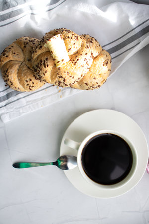 Breakfast with coffee and croissant on white table, top viewの写真素材