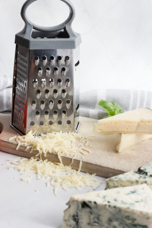 Cheese still life with grater and grater on white backgroundの写真素材