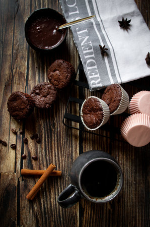 chocolate muffins and cup of coffee on wooden background top viewの写真素材