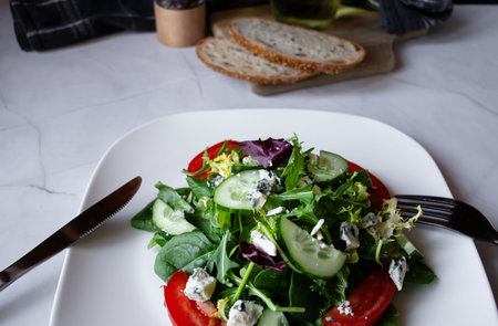 Fresh salad with blue cheese, arugula, cucumber and tomatoesの写真素材