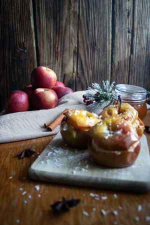 Baked apples with cinnamon and star anise on a wooden backgroundの写真素材