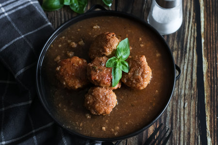 Meatballs with tomato sauce in a bowl on a wooden background.の写真素材