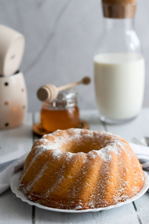 Homemade bundt cake with icing sugar and honey, selective focusの写真素材