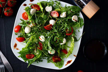 Fresh salad with arugula, cherry tomatoes and mozzarella cheeseの写真素材