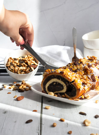 Poppy seed roll with nuts and raises on white background