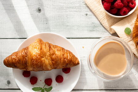 Breakfast with coffee and croissants on wooden table. Top viewの写真素材