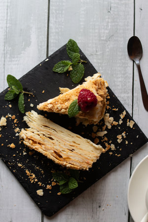 Slice of apple pie with raspberries and mint on a slate plateの写真素材