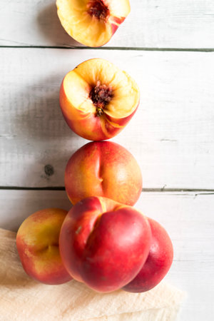 Ripe peaches on a white wooden background, top view.の写真素材