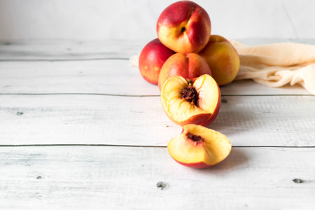 Ripe peaches on a white wooden background. Copy space.の写真素材