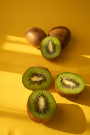 Kiwi fruit on a yellow background. The concept of healthy eating.の写真素材