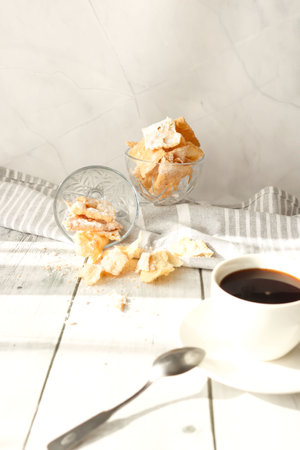 Cup of coffee and cookies on white wooden table, closeupの写真素材