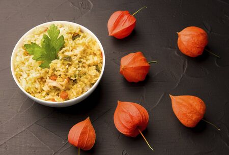 Rice with vegetables on black in the backgroundの写真素材
