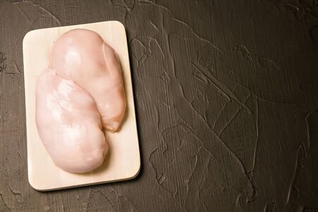 raw chicken on a black background with place for textの写真素材