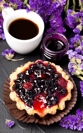 blackcurrant cake next to a cup of coffee and jamの写真素材