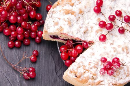 Pie on a black background next to red rowan berries. close-upの写真素材