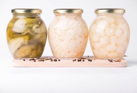 Pickled peppers, onions and cabbage on a white plate in a jarの写真素材