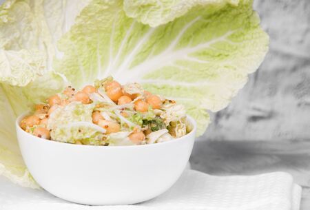 vegetarian salad in a white mask with chickpeas and cabbage on a light concrete backgroundの写真素材