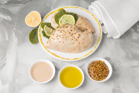 ready chicken next to sauces and mustard on concrete backgroundの写真素材
