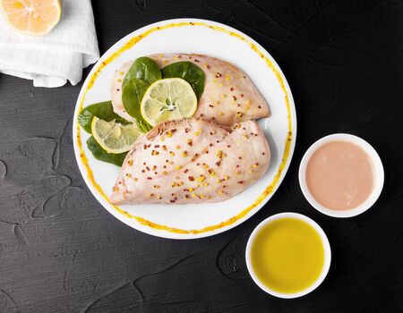 ready chicken next to sauces and mustard on a black background. view from aboveの写真素材
