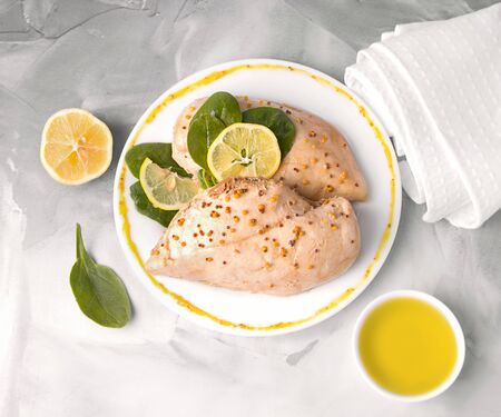 baked chicken fillet on a plate with mustard. on concrete backgroundの写真素材