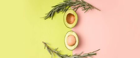 green and pink background with avocado. copy space