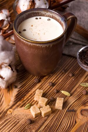 masala tea on a wooden table next to cane sugar. country styleの写真素材