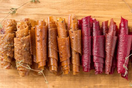 fruit rolls on a wooden board close-up. Useful sweets for children. Sweet Sugar Free Snacksの写真素材