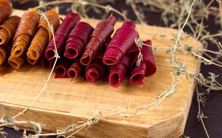 fruit rolls on wooden board close-up