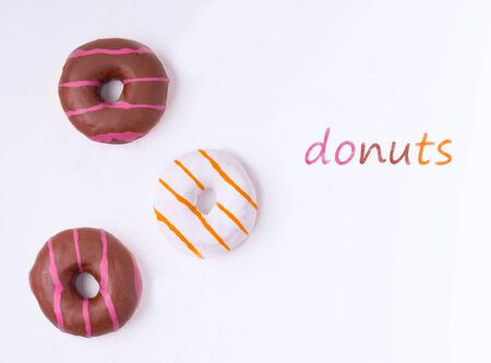 Donuts with white and chocolate icing on a white background. sweetsの写真素材