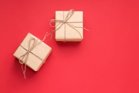 two gifts on a red background in craft paper copy space. Valentine's Day Giftの写真素材