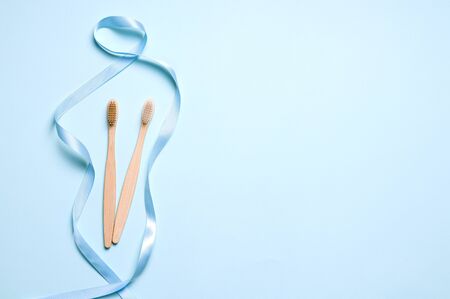 two bamboo toothbrushes on a blue background. have copy space. Horizontal Image Zero Waste Conceptの写真素材