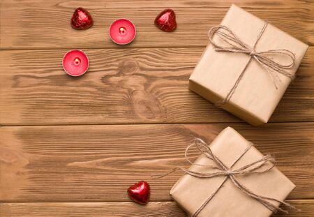 gifts on a wooden table. Close to sweets and sweets. There is a text. Valentine's Day celebration concept.の写真素材