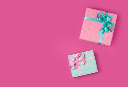 two gifts pink and mint on a pink background copy spaceの写真素材